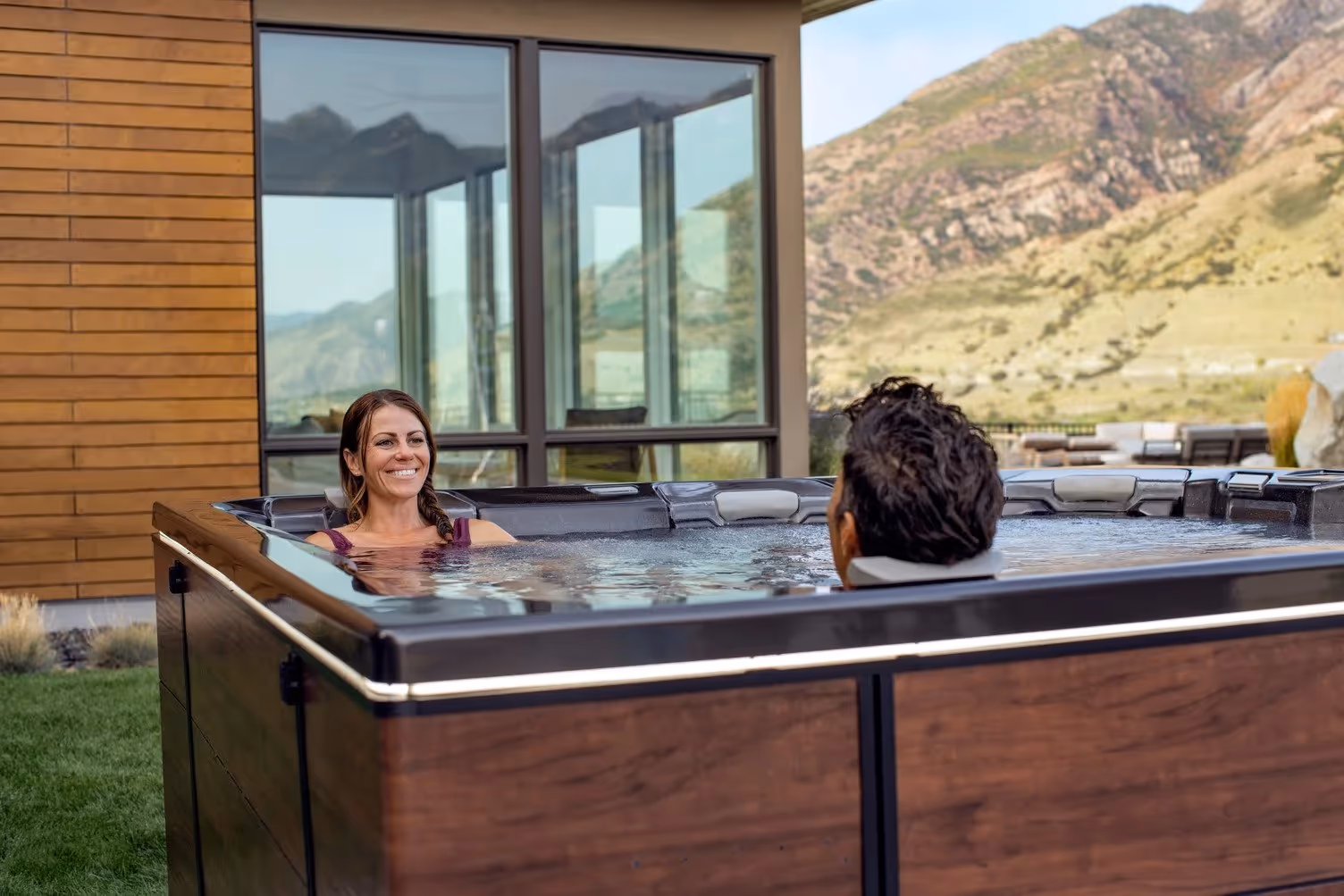 A Bullfrog Spa on a backyard patio showcasing its premium design and features.