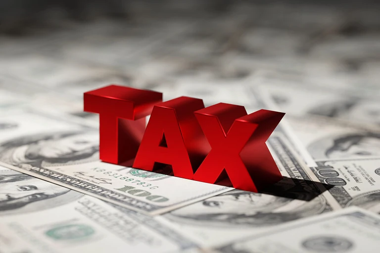 the word "tax" sitting on dollar bills