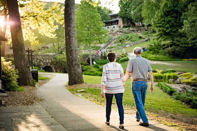 Retired couple walking through a park