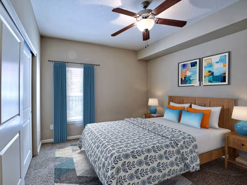 Virtually staged bedroom with bed, bedside table, and large window