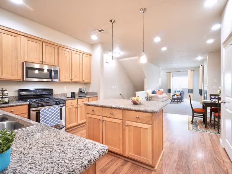 Kitchen with brown wood cabinets featuring an island and stainless steel appliances