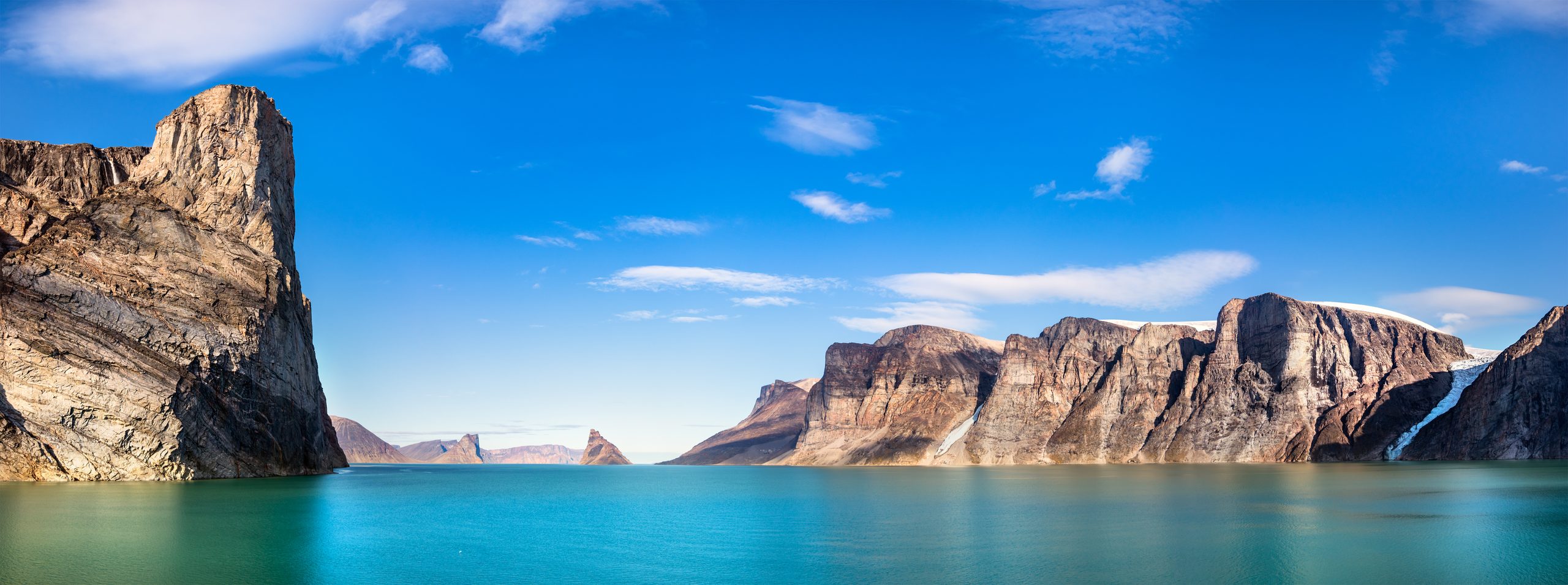 Steep cliffs meeting the water on Baffin Island, Nunavut.