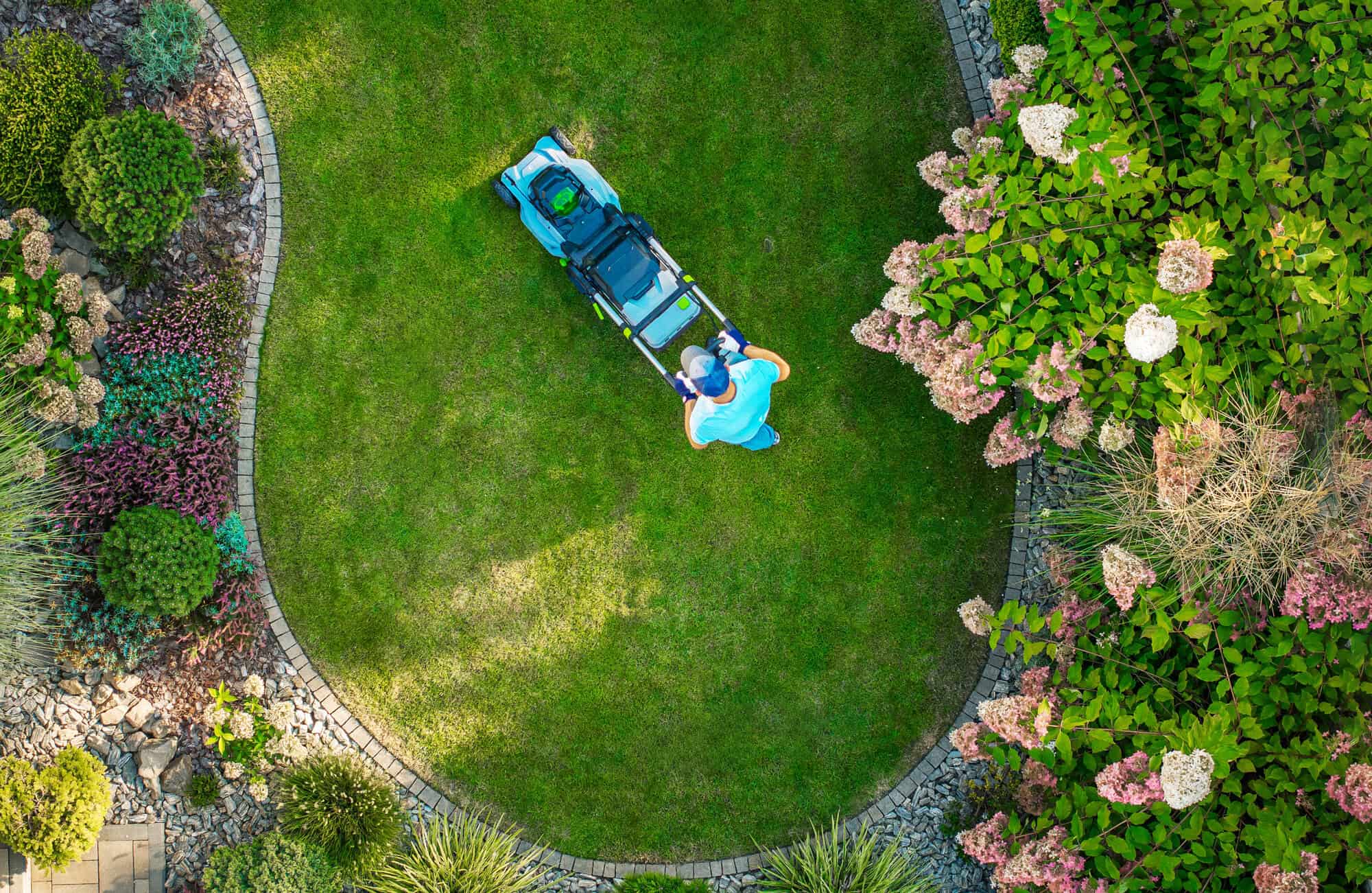 A person moving a lawn in circles