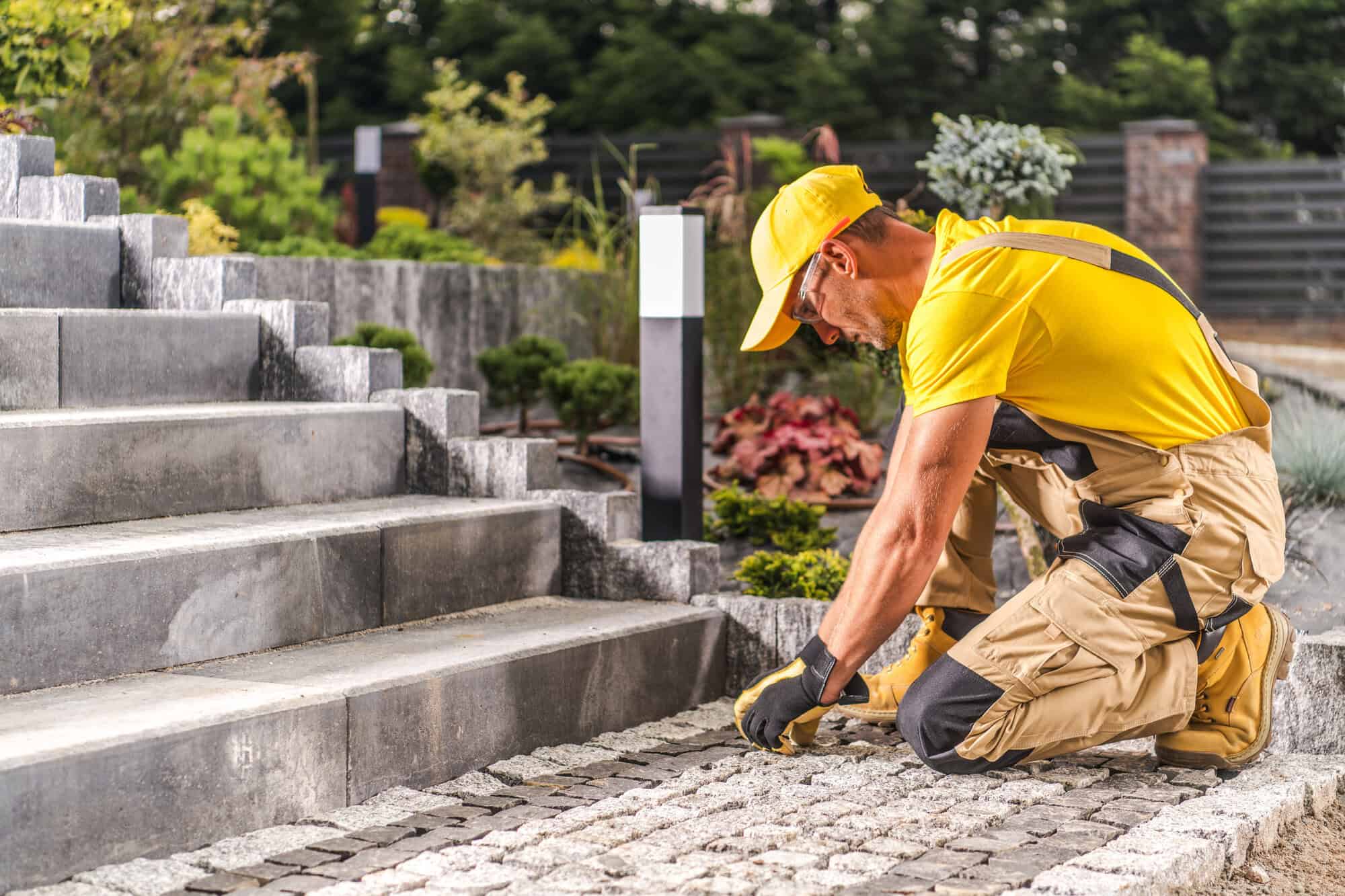 A person laying down bricks