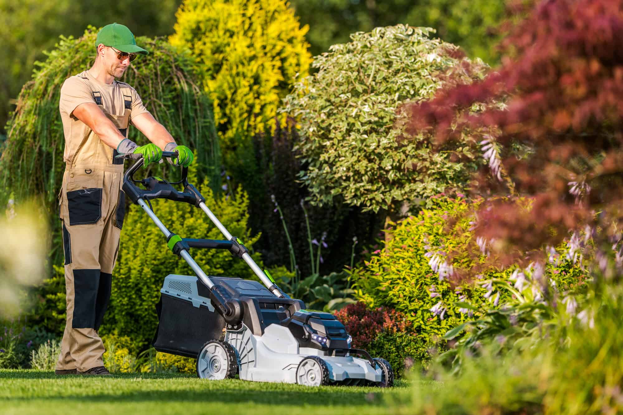 A gardener mowing grass