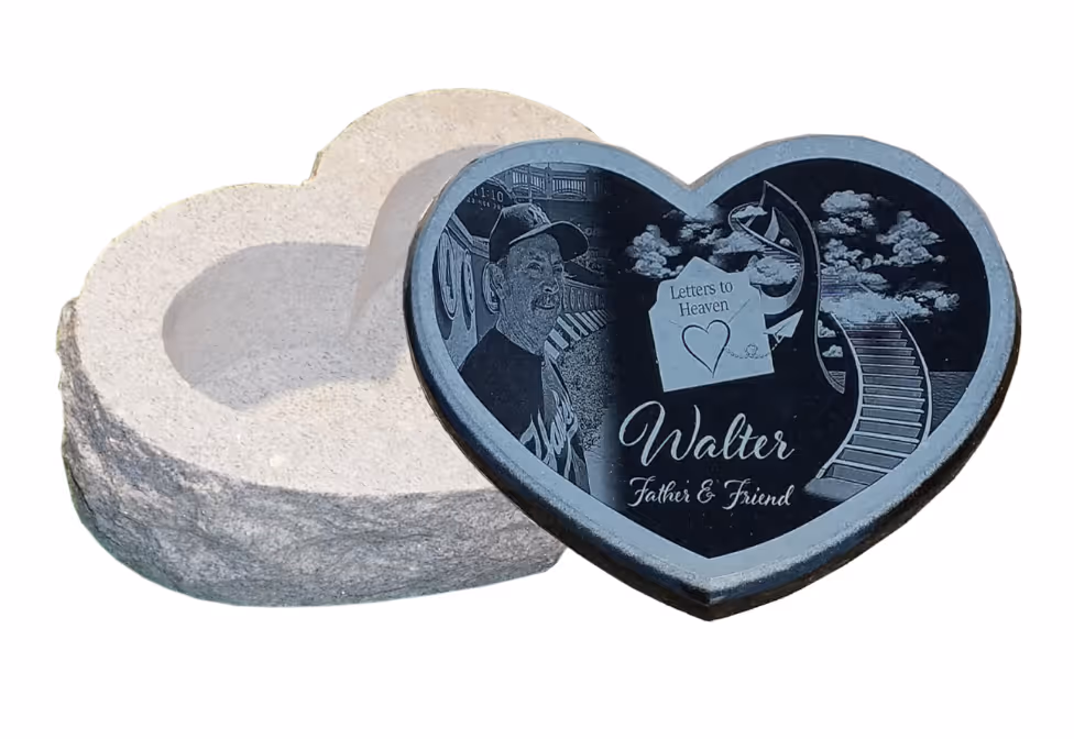 granite cremation memorial in the shape of a heart with custom etching on the top