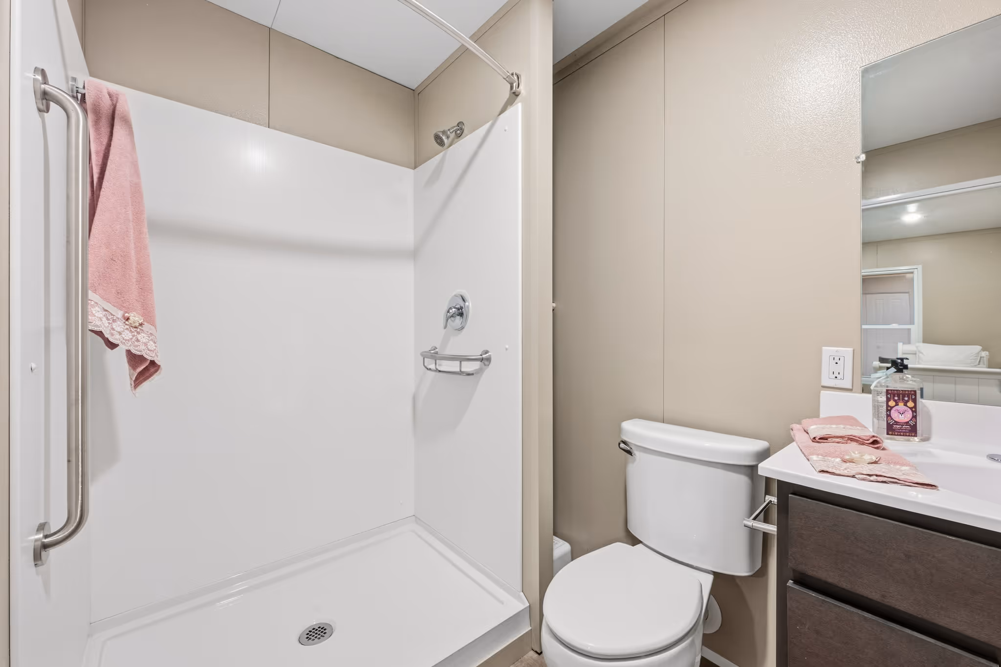 Walk-in shower with non-slip flooring and grab bars