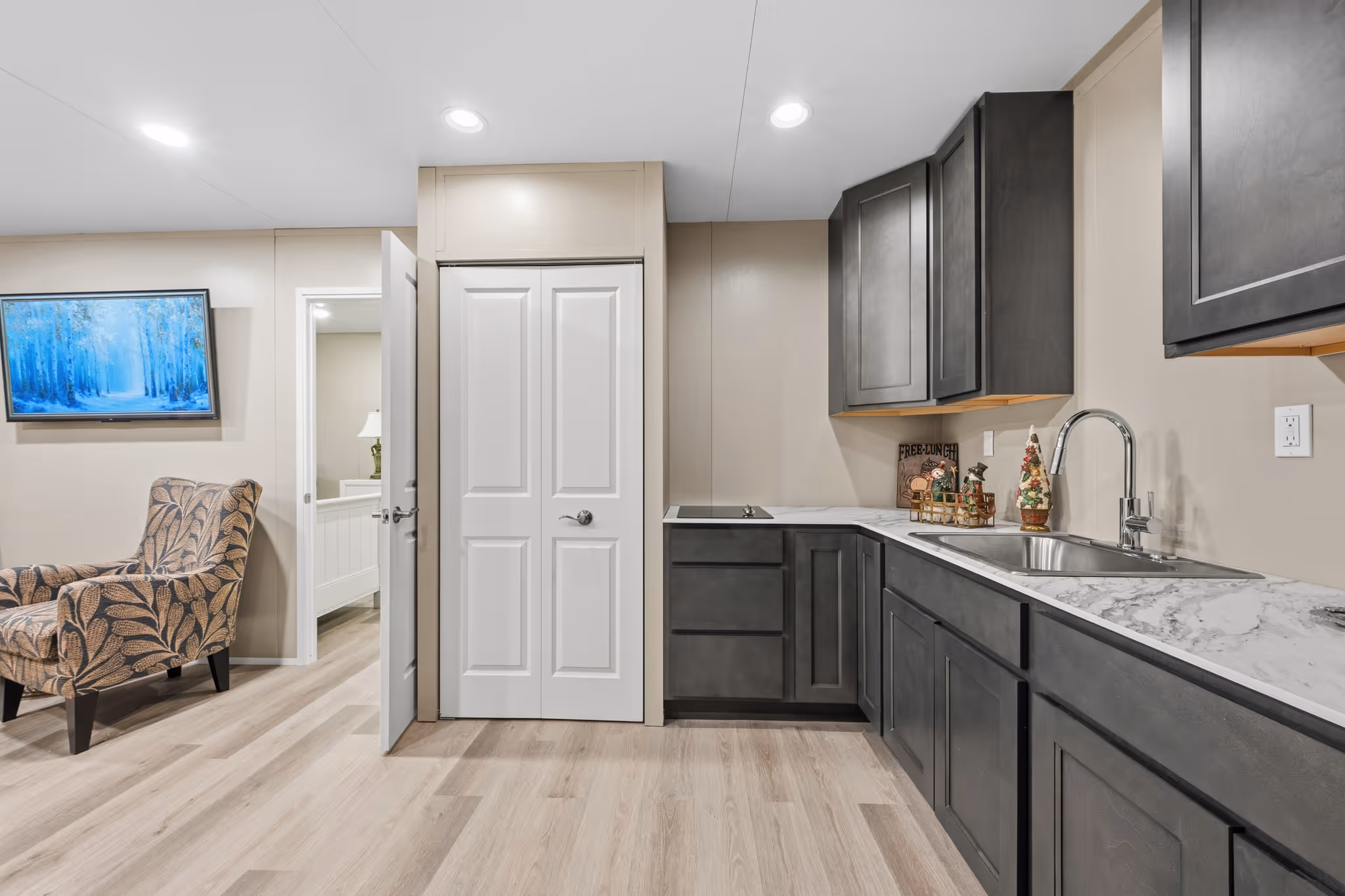 Accessible workspace with cabinents, refrigerator, and sink.