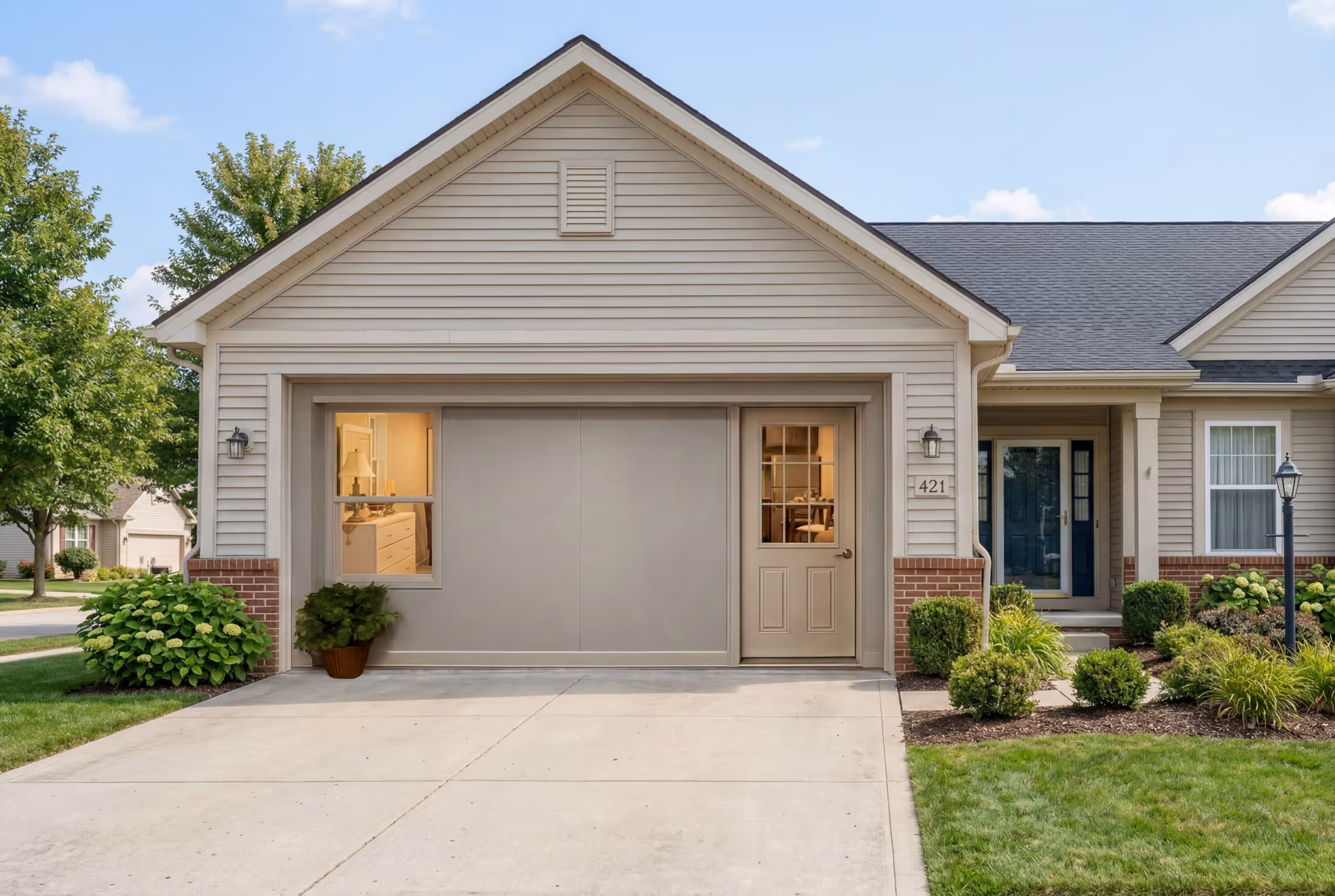 Single-car garage exterior with neutral siding and residential driveway. The Honey Suite exterior wall is visible.