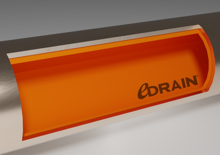 Close-up of a metal pipe with an orange interior lining labeled 'edrain'.