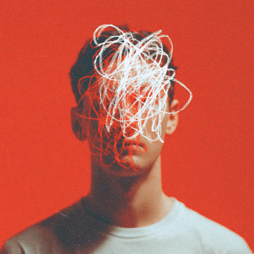 Portrait of a man with face obscured by an abstract white scribble on a red background.