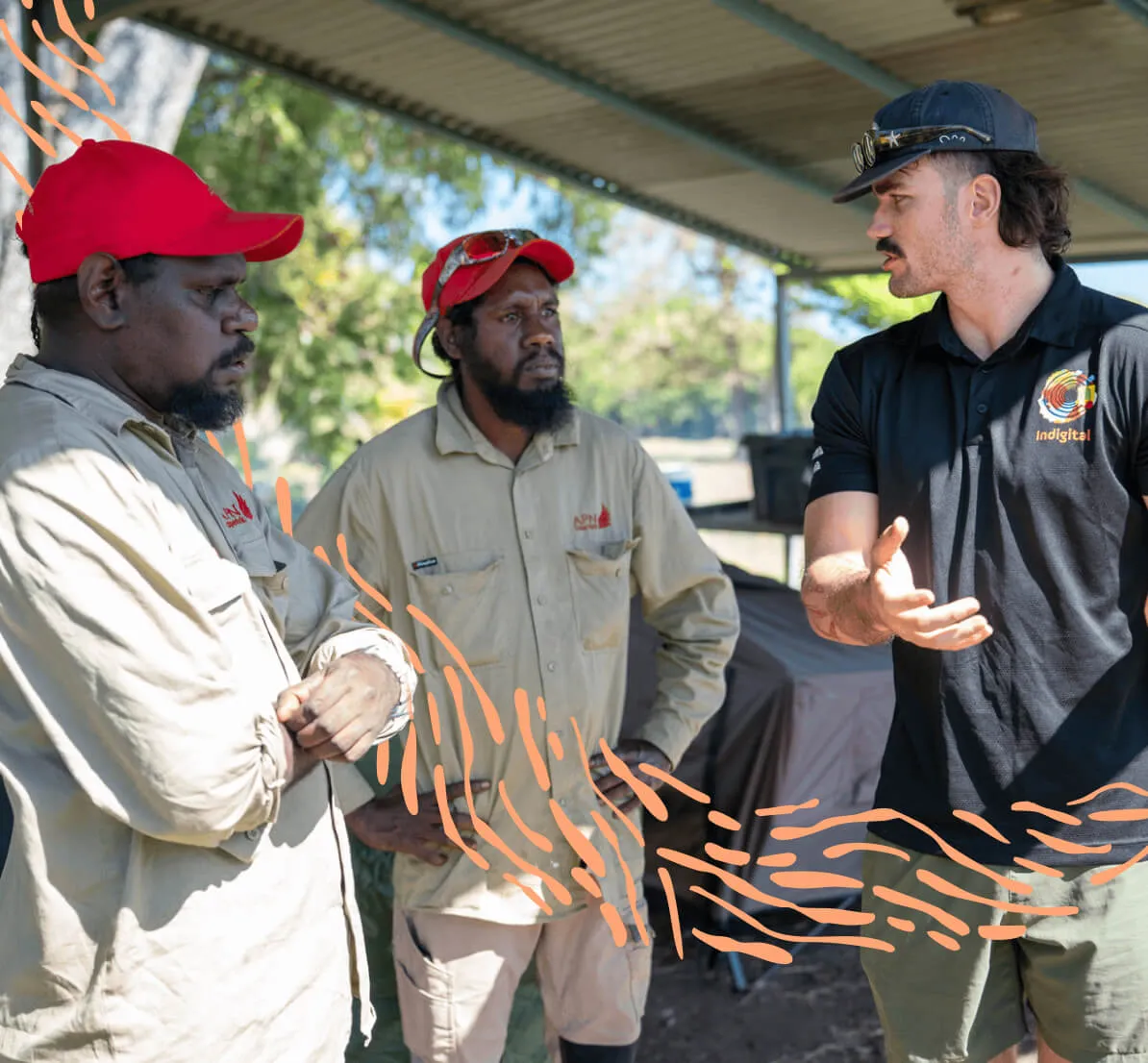 Indigital team member in discussion with two community members on Country
