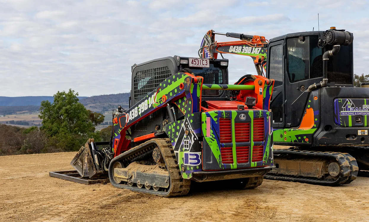 Balint Building & Earthworks skid steer loader and excavator on a construction site.