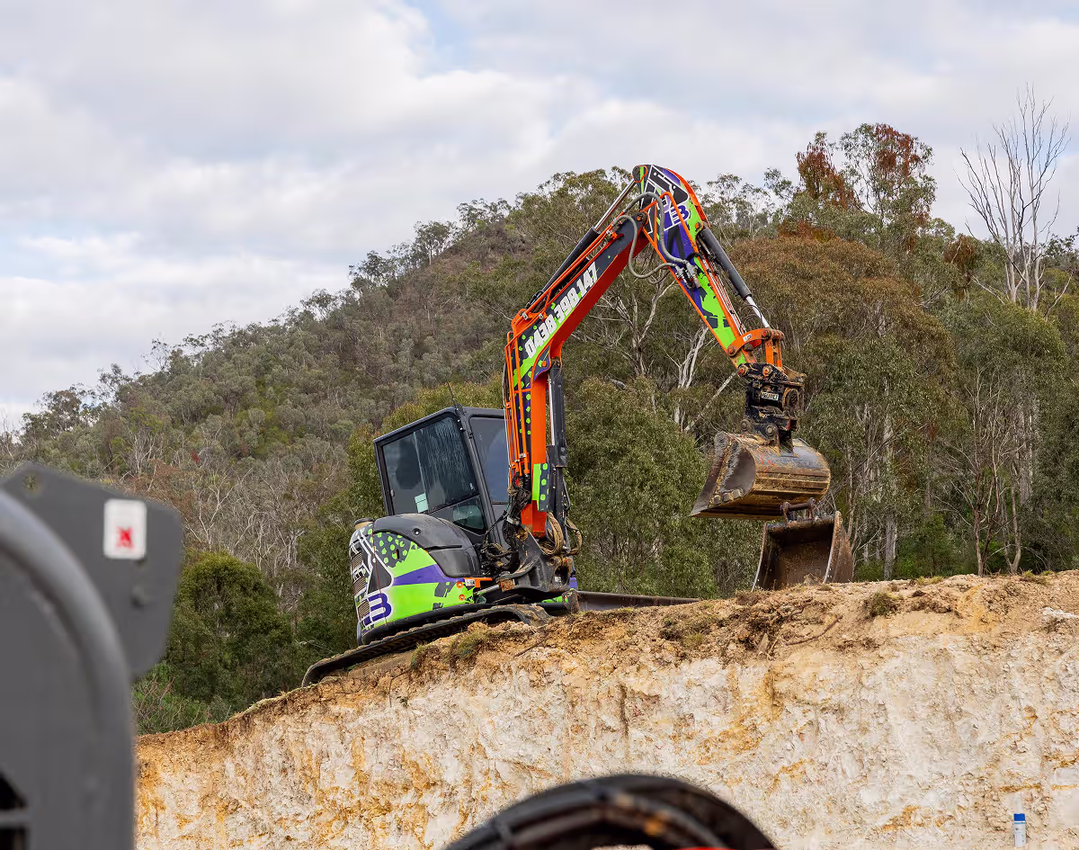 Excavator carrying out earthmoving work on a Warwick project