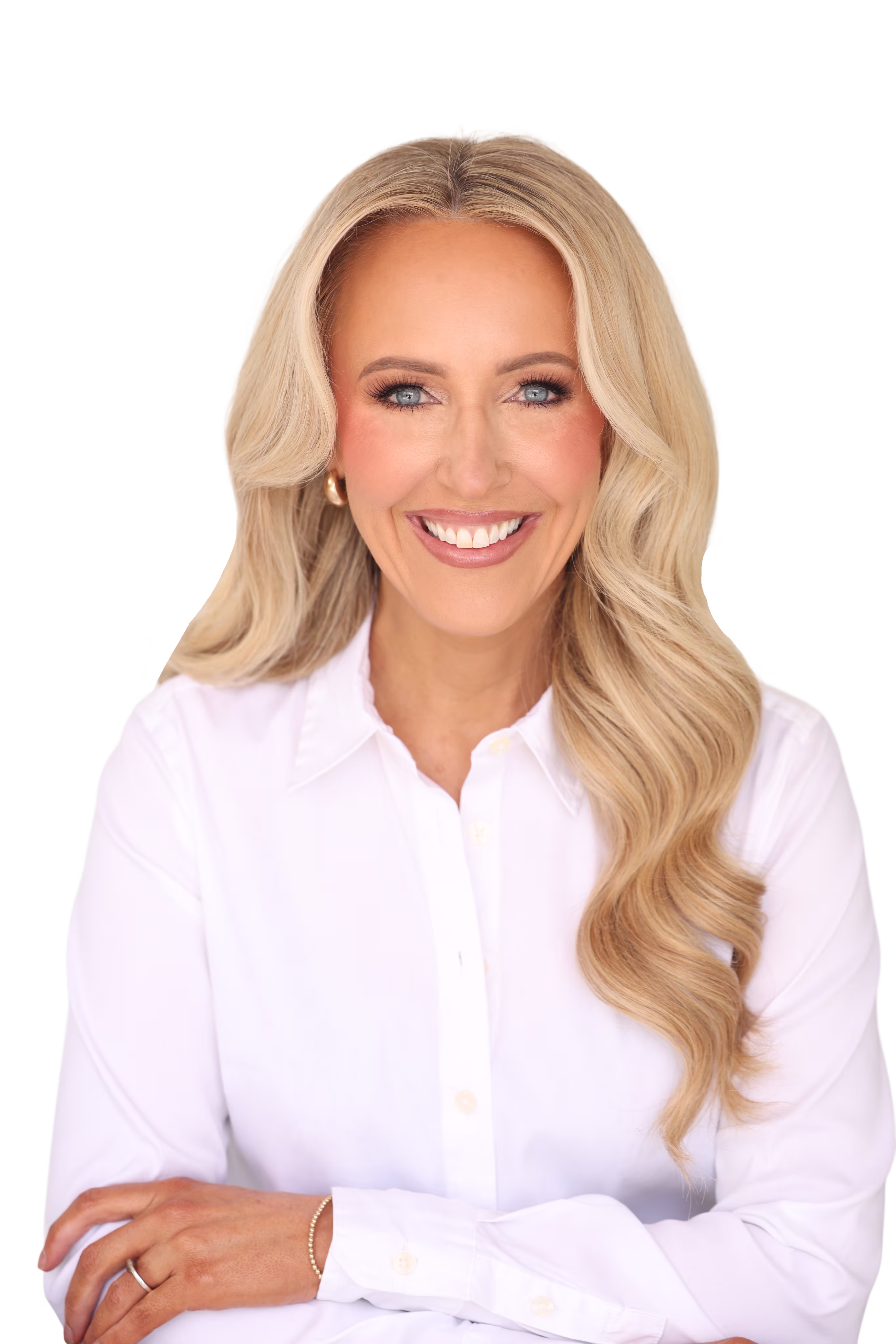 Smiling woman with long blonde hair wearing a white button-up shirt and gold hoop earrings.