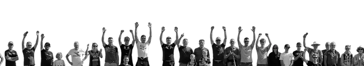 Large group of people standing and raising their arms together in celebration.