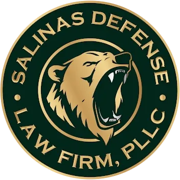 Salinas Defense Law Firm, PLLC emblem featuring a roaring bear head in gold on a dark green circular background.