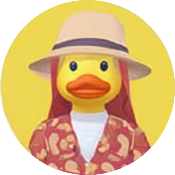 Yellow rubber duck wearing a beige wide-brimmed hat and a red patterned jacket over a white shirt, set against a yellow background.