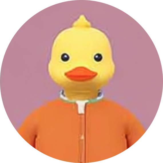 Person wearing a large yellow rubber duck mask with an orange beak and an orange jacket against a purple background.