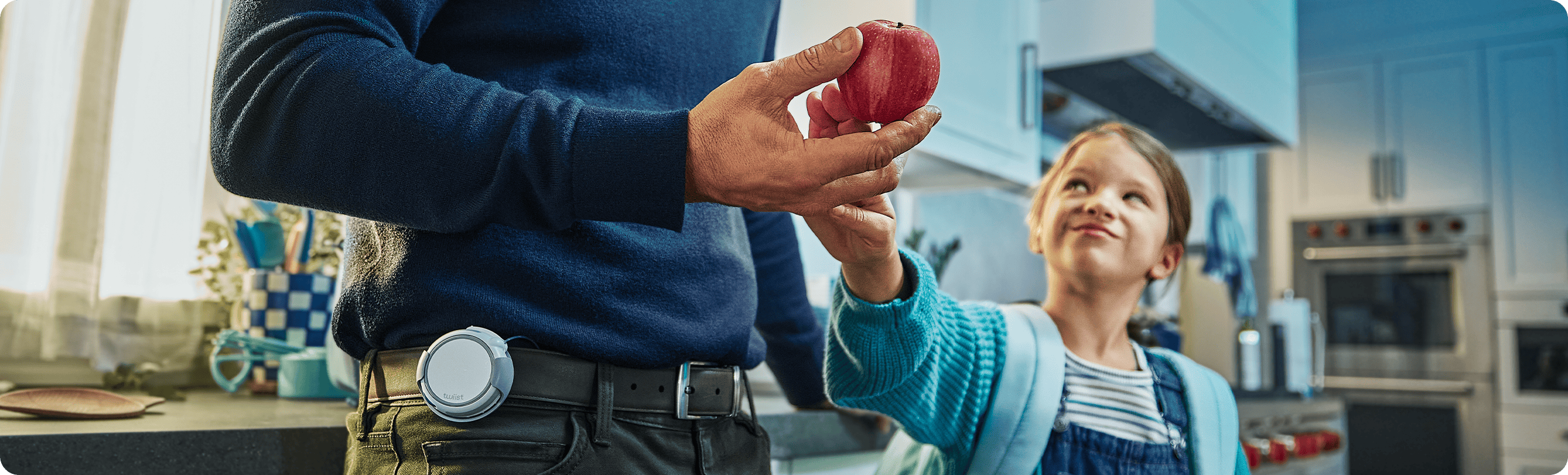Image: Daughter grabbing apple from Father who is wearing the twiist device