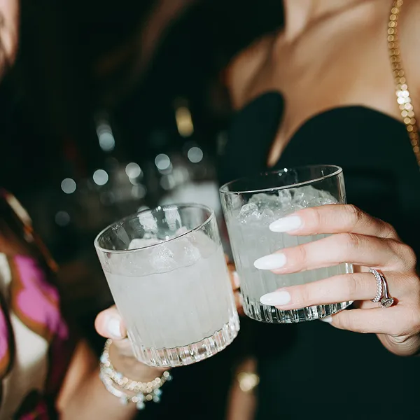 Guests with watermelon coolers at an event catered by Bartleby & Sage. 