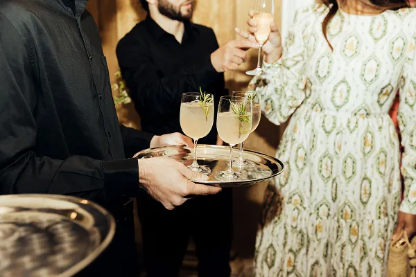 Guests with drinks at a gala catered by Bartleby & Sage. 
