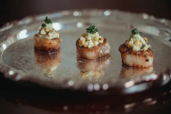 A scallop and corn bite created by Bartleby & Sage