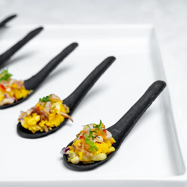 A seafood paella bite prepared by the Bartleby & Sage culinary team