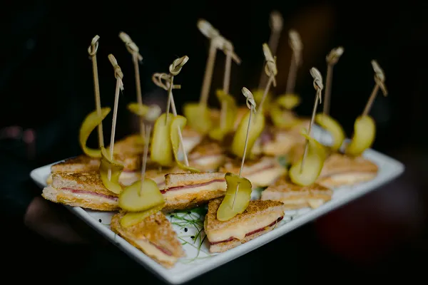 A mini Reuben sandwich passed at a Bartleby & Sage event