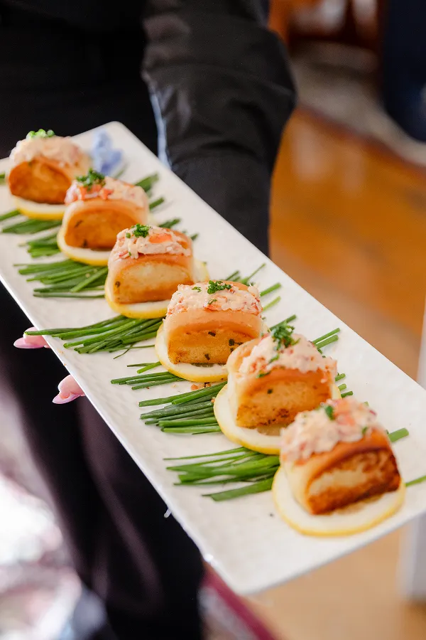 A close-up of a mini Maine lobster roll served by Bartleby & Sage