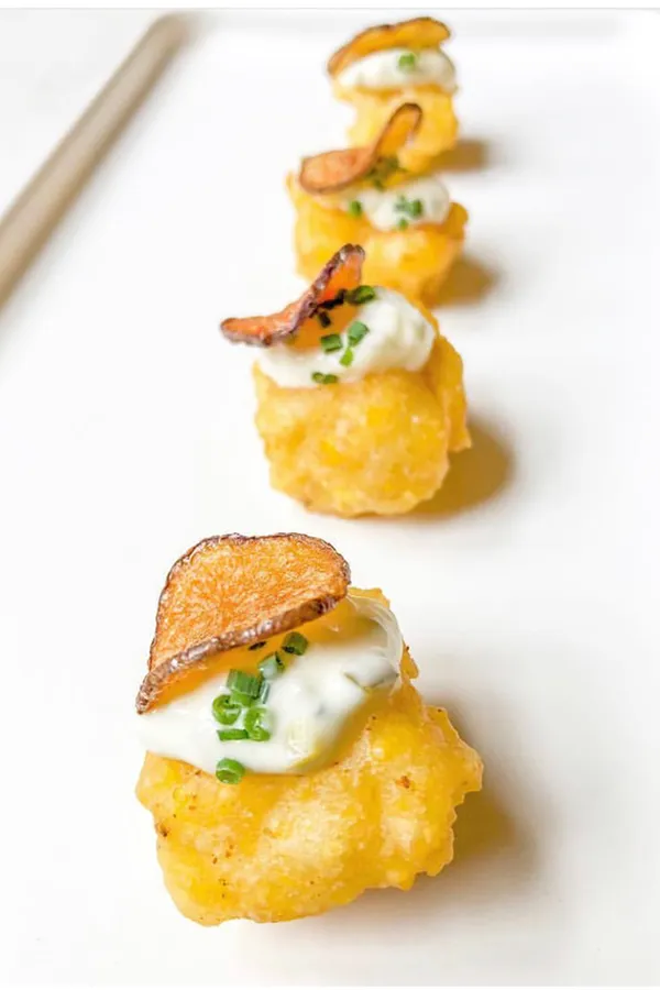 A deconstructed fish and chips bite plated by Bartleby & Sage