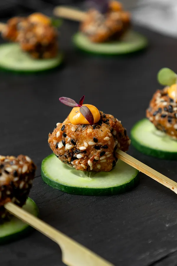 Black sesame crusted chicken bites served by Bartleby & Sage