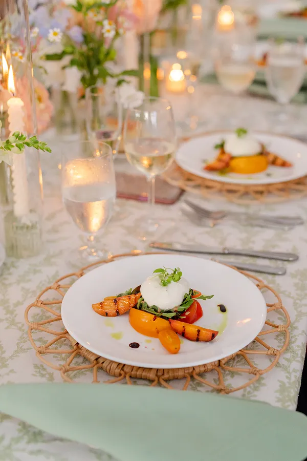 Grilled peach and burrata plated by Bartleby & Sage