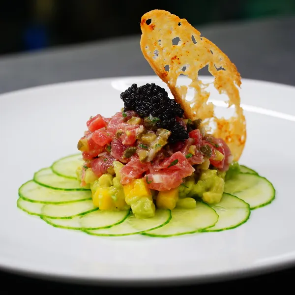 Tuna avocado tartare topped with caviar, plated by the Bartleby & Sage culinary team
