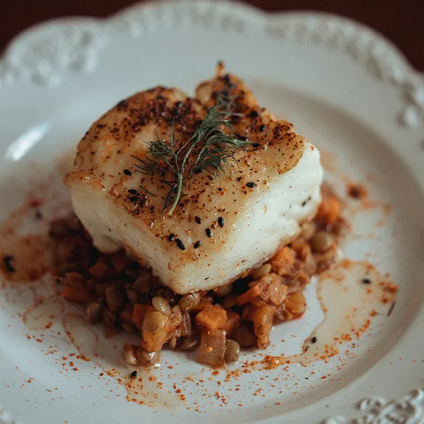Oven-baked sea bass prepared by the Bartleby & Sage culinary team