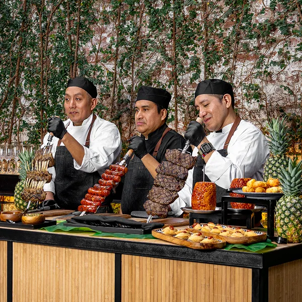 Bartleby & Sage chefs at a Brazilian rodizio meat station.