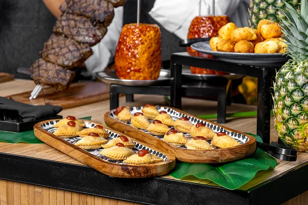 A duck confit empanada station catered by Bartleby & Sage.