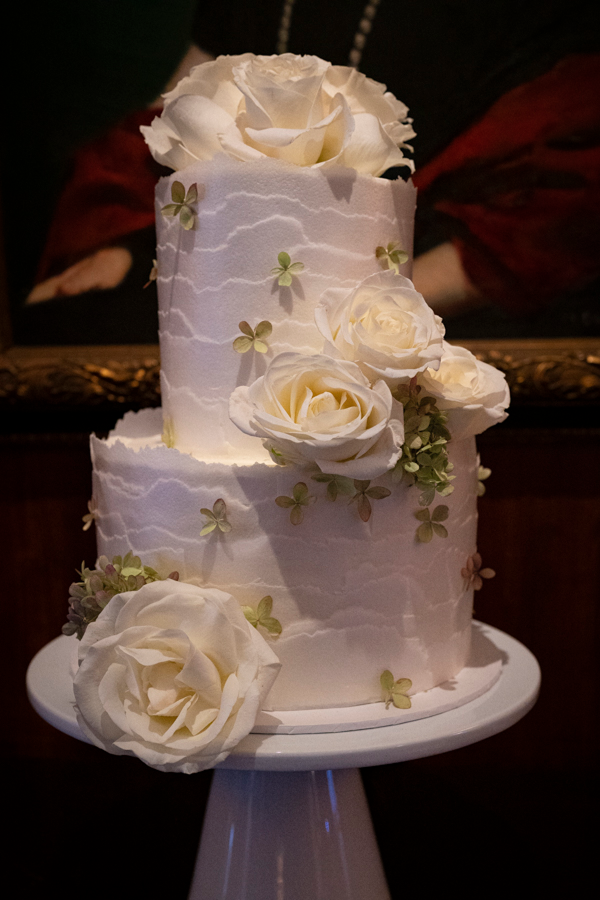 A roses and ruffles wedding cake at a wedding catered by Bartleby & Sage.