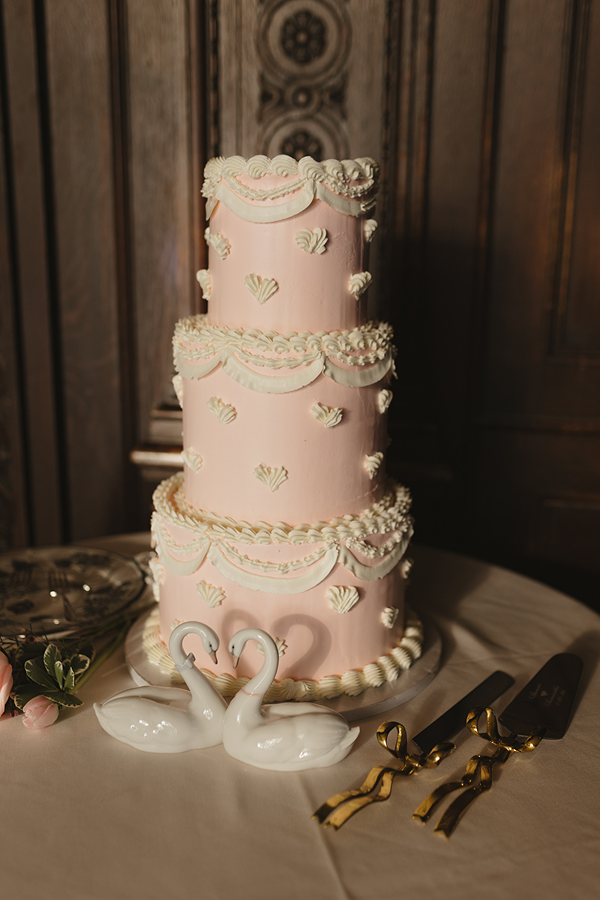 A pink vintage three-tier wedding cake made by the pastry chefs of Bartleby & Sage.