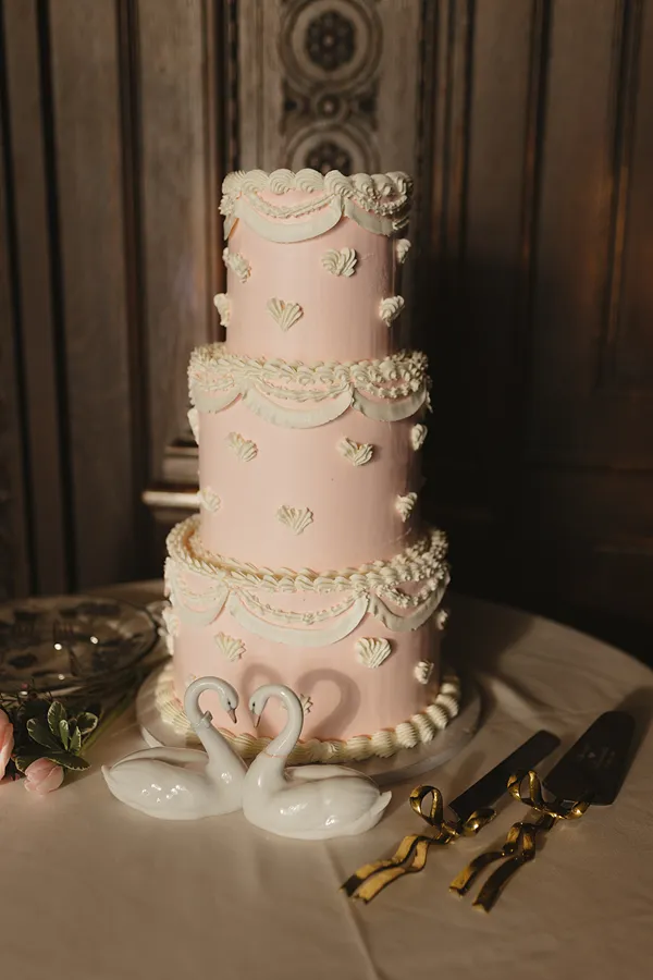 A pink vintage three-tier wedding cake made by the pastry chefs of Bartleby & Sage.