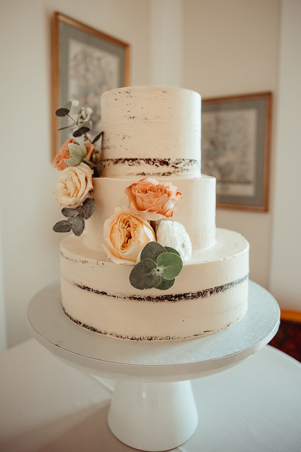 A semi-naked wedding cake at a wedding catered by Bartleby & Sage.