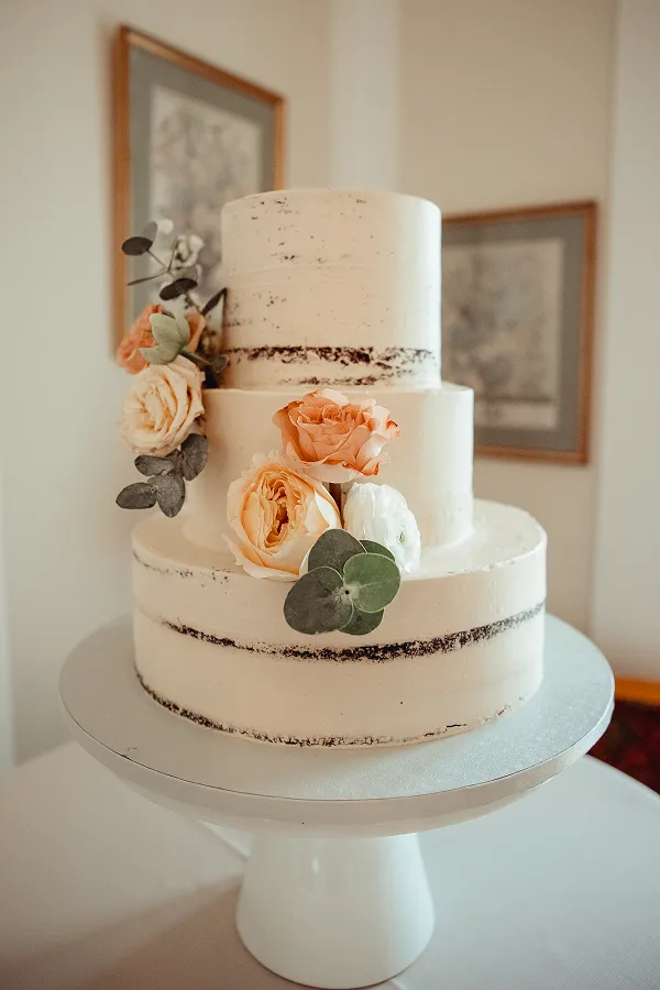 A semi-naked wedding cake at a wedding catered by Bartleby & Sage.