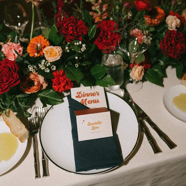 A styled menu card and florals for a wedding planned by Bartleby & Sage.