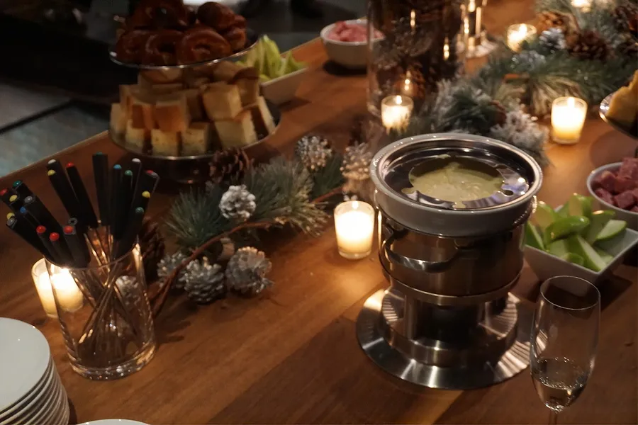 Cheesy fondue and items to dip into it at a holiday party catered by Bartleby & Sage