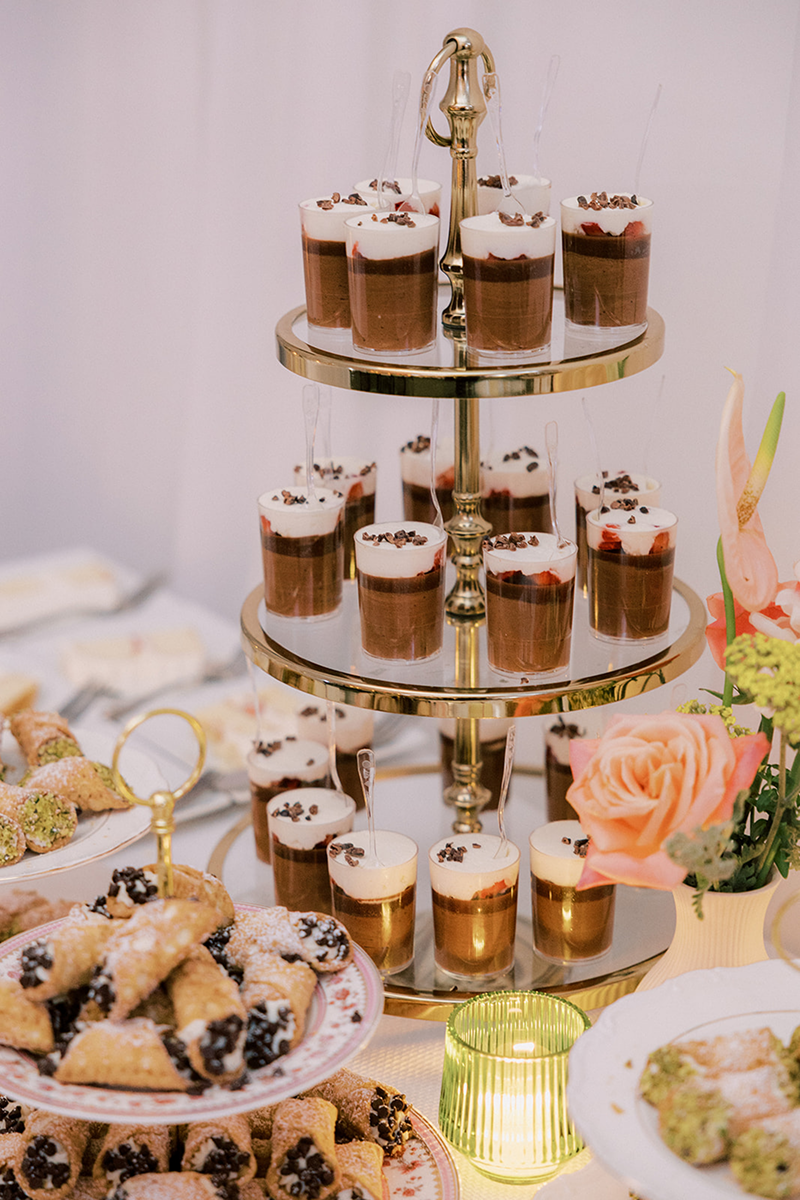 A tower of mini-chocolate cakes and surrounding plates of sweet treats made by the dessert chefs at Bartleby & Sage.