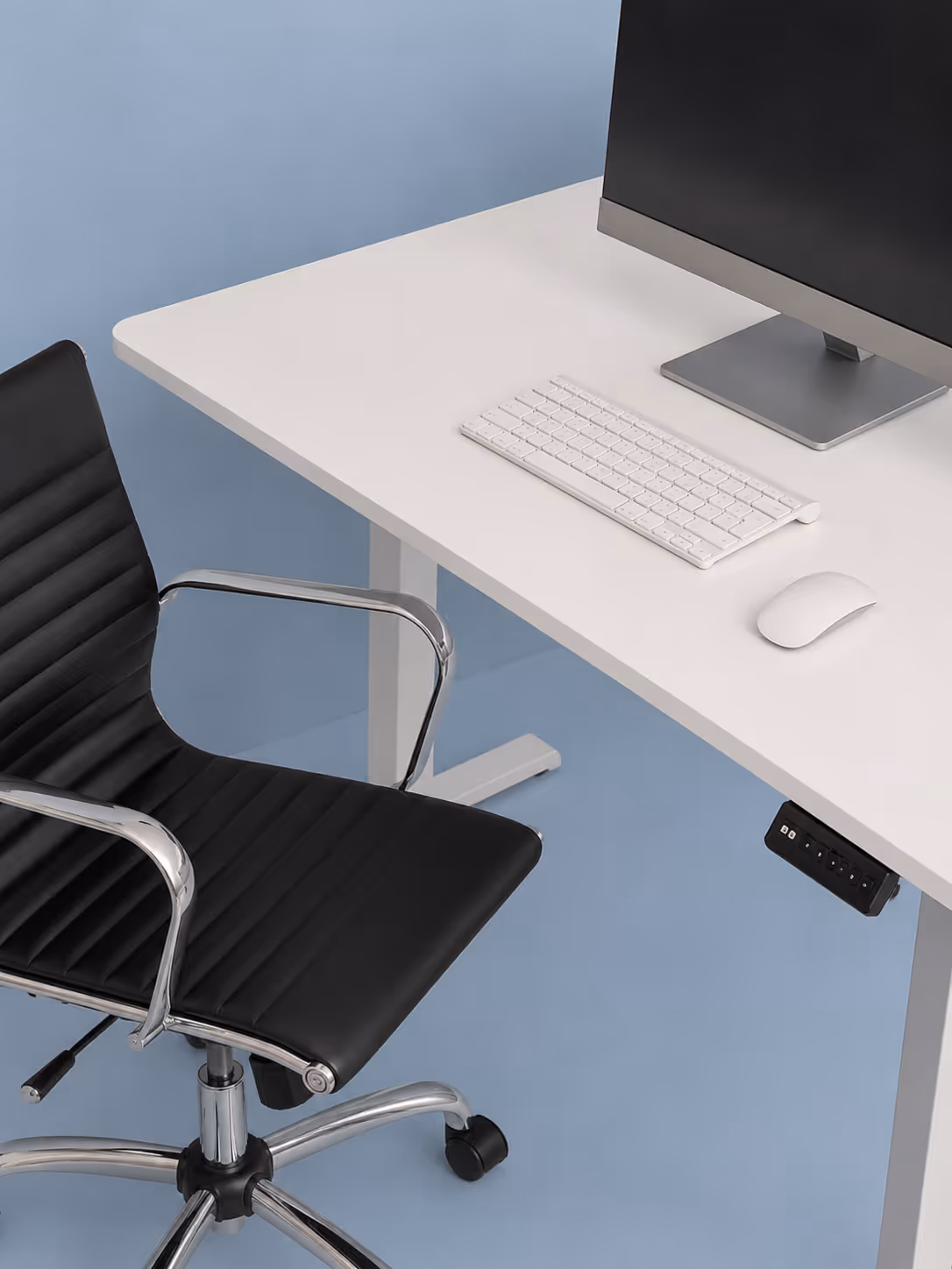 Modern office setup with black swivel chair, white desk, keyboard, mouse, and monitor on blue floor.