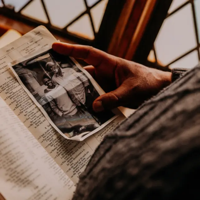 Black and white picture in a Bible of 2 people hugging and posing