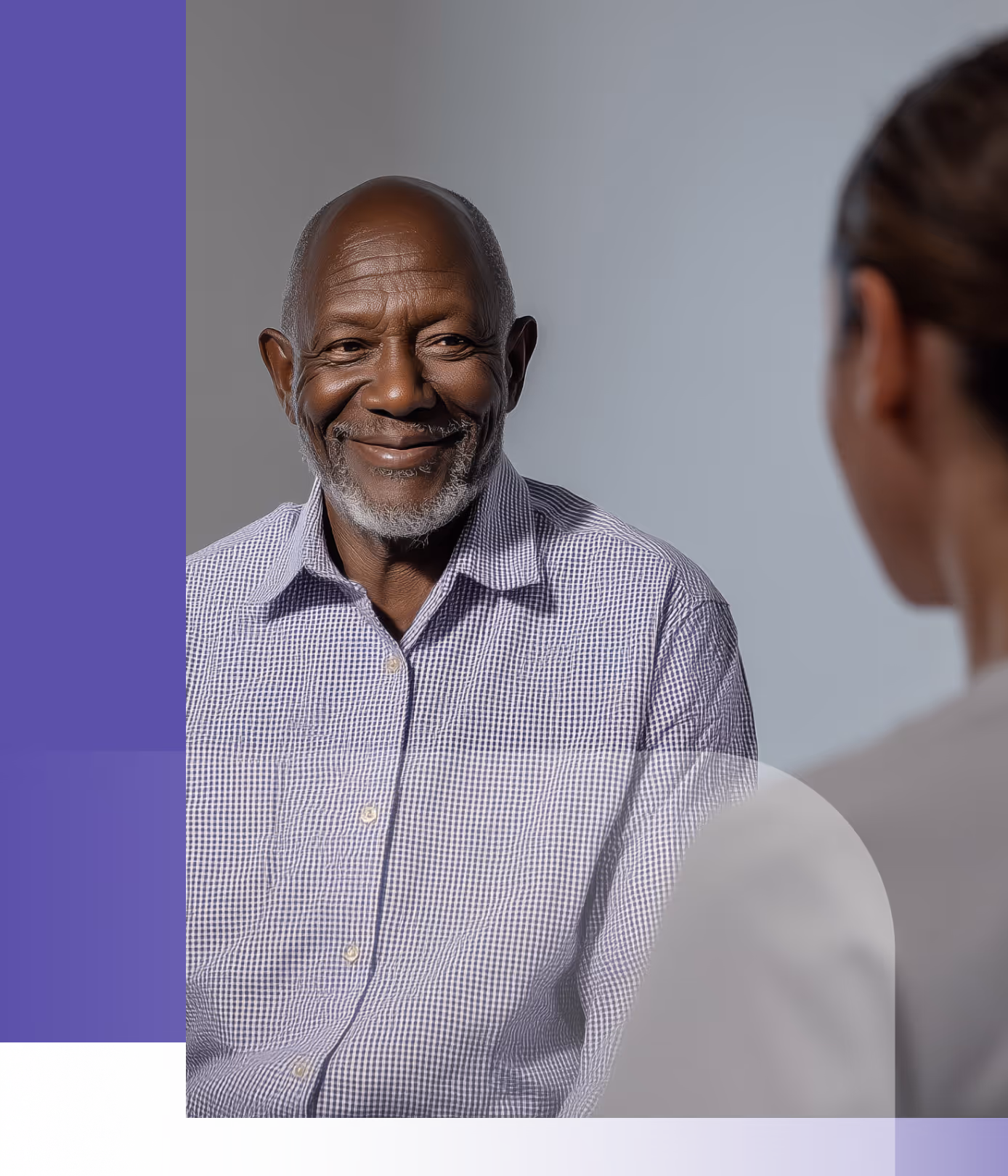 Smiling elderly man with a checkered shirt facing a woman with blurred features in the foreground.