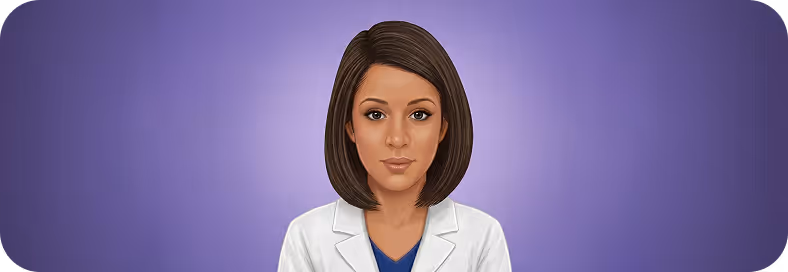 Portrait of a woman with straight brown hair wearing a white coat over a blue shirt.