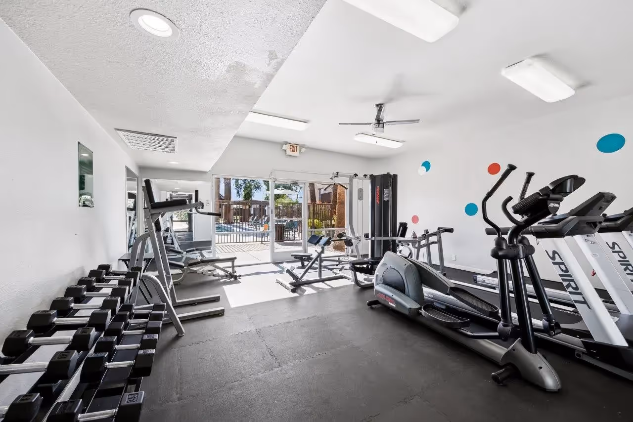 Gym with dumbbells and stationary bikes